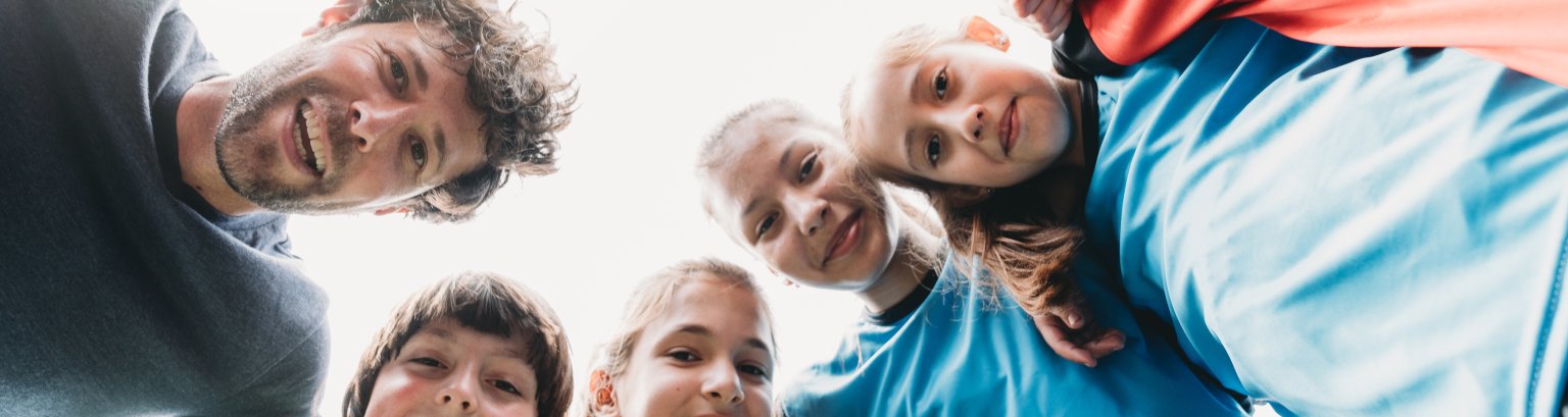 Low angle view of kids Football School Team looking together at camera