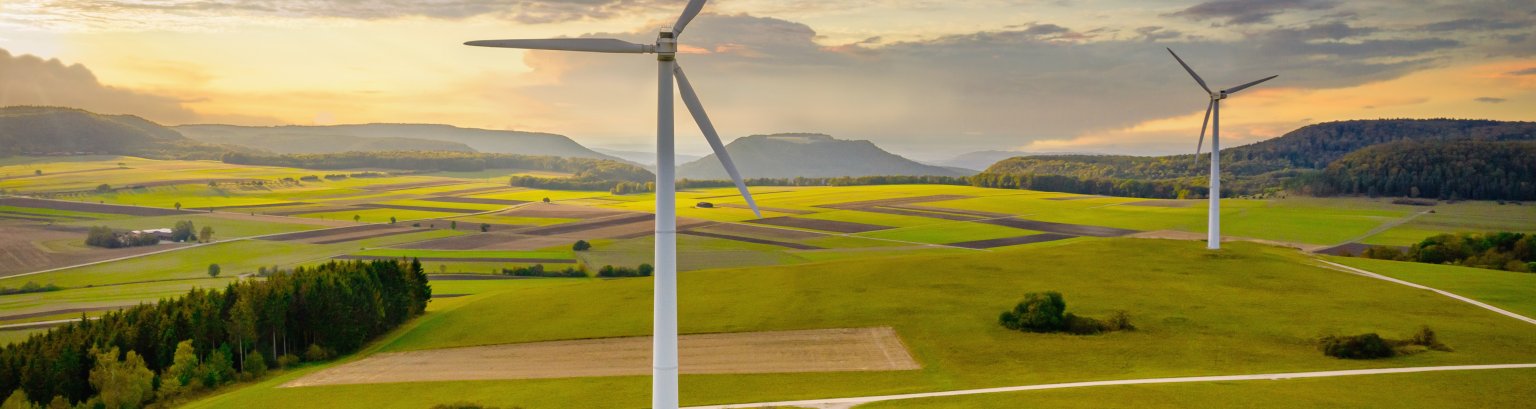 Alternative Energy Wind Turbine Green Landscape at Sunset