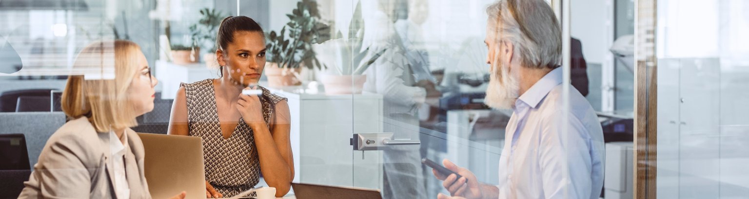 Business People Sitting at Desk, Discussing