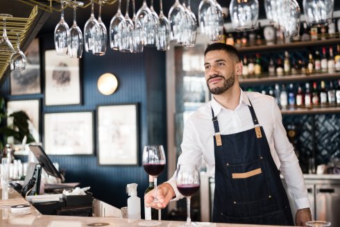 Bartender offering a glass of wine Bartender offering a glass of wine
