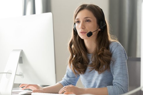 Businesswoman in headset call center agent consulting participating video conference Businesswoman in headset call center agent consulting participating video conference